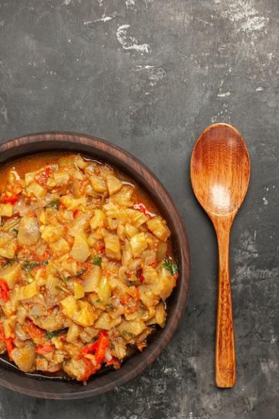 Roasted Aubergine Salad in a Bowl with Wooden Spoon on Dark Surface – Free Stock Photo, Download Free