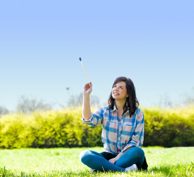 Relaxed Woman Sitting with a Stick – Free Download, Free Stock Photo