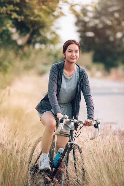 Asian Young Woman Riding Bicycle for Exercise and Recreation | Free Download