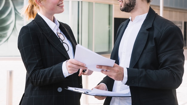 Businessman and Businesswoman Holding Documents – Free Stock Photo, Download for Free