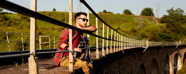 Man Sitting at Bridge Edge – Free Stock Photo, Download Free