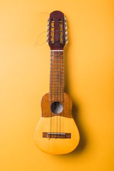 Ukulele with Broken String on Yellow Background – Free Download