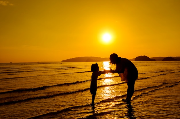 A Mother and Son Outdoors at Sunset with Copy Space – Free Download