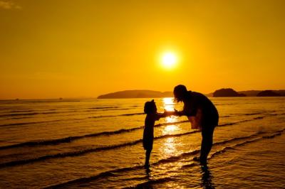 A Mother and Son Outdoors at Sunset with Copy Space – Free Download