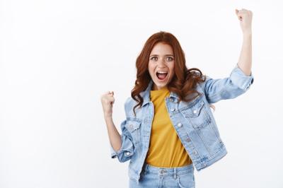 Excited Redhead Woman Celebrating Success with Fist Pump – Free Download