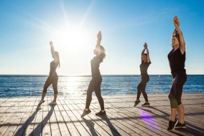 Sportive Women Dancing Zumba Near the Sea at Sunrise – Free Download