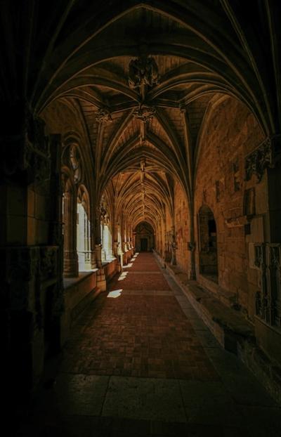 Vertical Shot of an Old Building’s Hallway with Windows and a Door in the Distance – Free Download