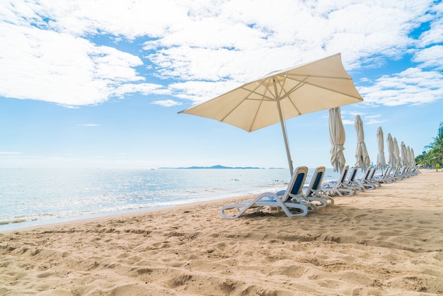 Beautiful Tropical Beach Scene with Umbrella and Chair – Free Download