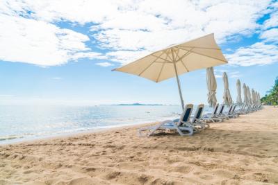 Beautiful Tropical Beach Scene with Umbrella and Chair – Free Download