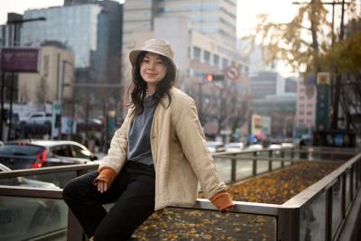 Young Woman in a Bucket Hat in the City – Free Stock Photo for Download