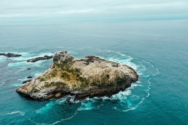 Aerial Drone Shot of a Small Rocky Island in a Beautiful Blue Ocean – Free Stock Photo, Download for Free