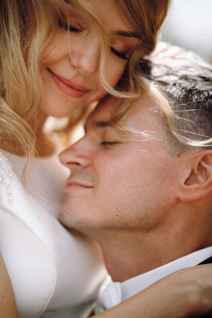 Groom in Black Tuxedo Embracing Stunning Bride – Free Download