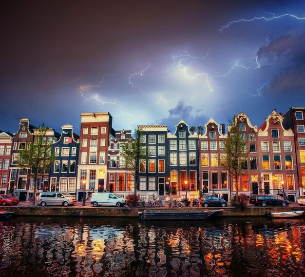 Stunning Amsterdam Canal Under Cumulus Clouds and Lightning – Free Download