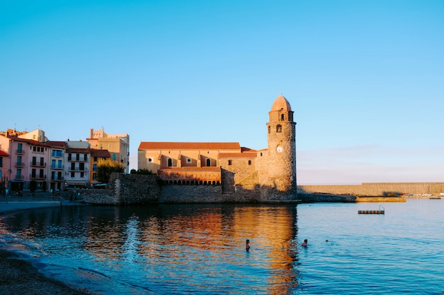 Old Castle Reflection in Calm Sea Under Blue Sky – Free Download