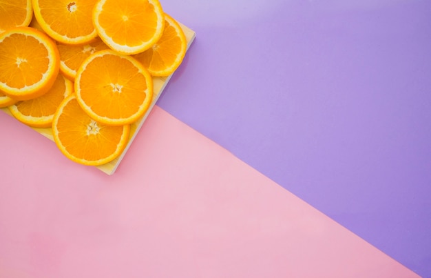 Vibrant Purple Surface Featuring Fresh Orange Slices – Free Download