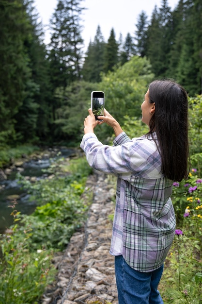 A Young Woman Photographing in the Mountain Forest – Free Download