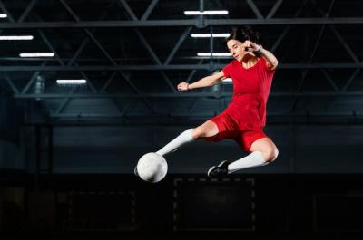 Dynamic Woman Jumping to Kick a Ball – Free Stock Photo for Download