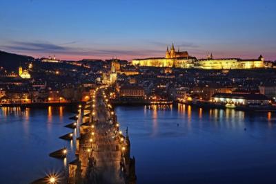 Illuminated Buildings and Bridge in City at Dusk – Download Free Stock Photo