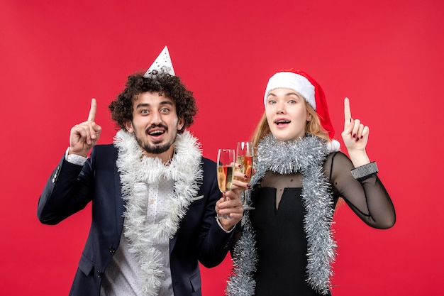 Young Couple Celebrating New Year in Front of a Red Wall – Free Stock Photo, Download for Free