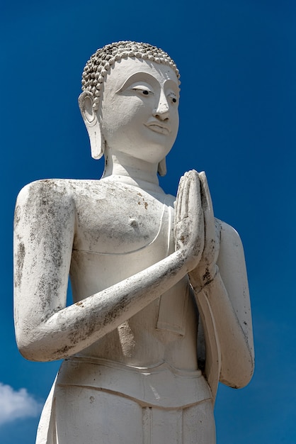 Old Buddha Statue Against a Clear Blue Sky – Free Download