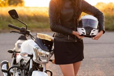 Woman Posing Next to Motorcycle Holding Helmet – Free Stock Photo for Download