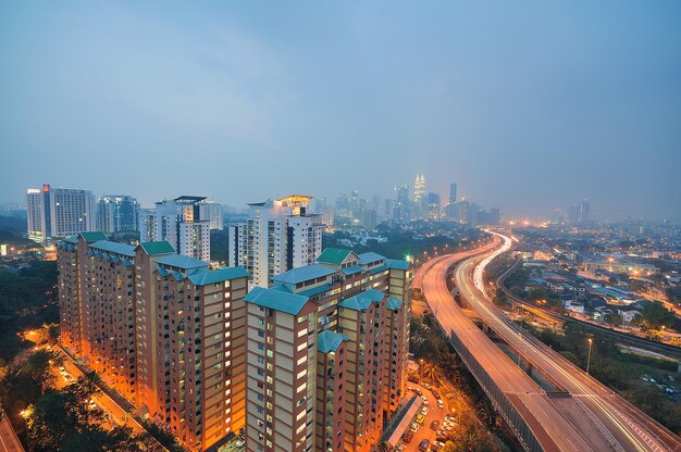 Illuminated City Buildings Against Sky – Free Stock Photo for Download