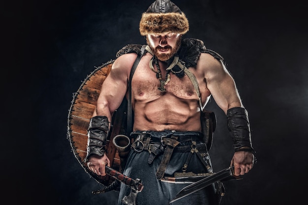 Severe Barbarian Warrior Posing on Dark Background – Free to Download