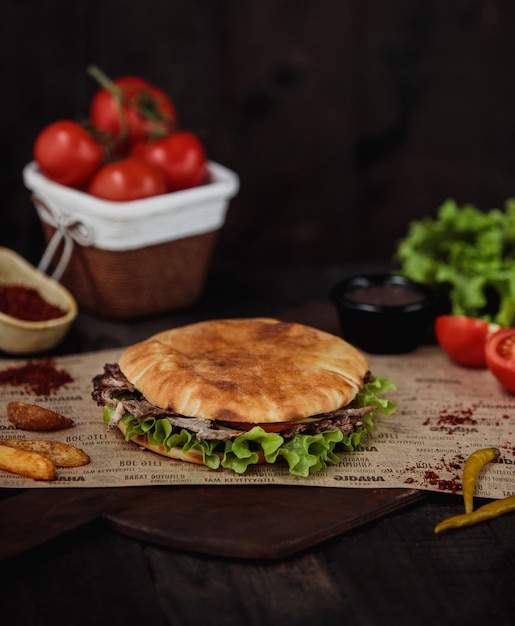 Side View of Doner Kebab with Fried Potatoes on Wooden Cutting Board – Free Download