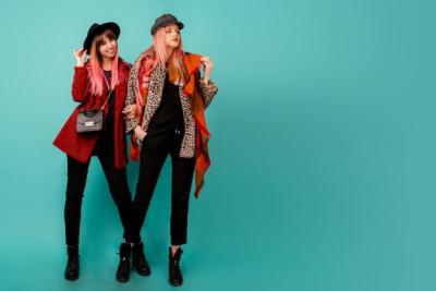 Two Beautiful Women in Stylish Faux Fur Coats and Wool Scarves on Turquoise Wall – Free to Download