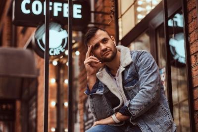 Stylish Man in Denim Jacket with Headphones and Coffee – Free Download