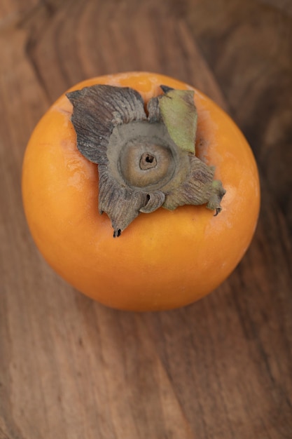 Ripe Persimmon Fruit on Wooden Surface – Free to Download