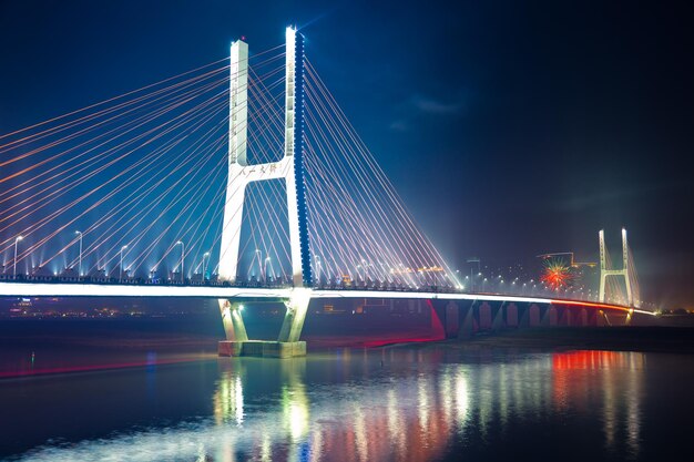 Illuminated Bridge Over River at Night – Free Stock Photo for Download