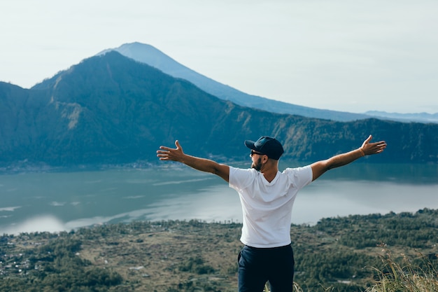 Young Guy with a Beard and Backpack Posing in a Jungle – Free Download