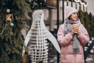 Young Woman Enjoying Coffee in a Winter Street Scene – Free Download