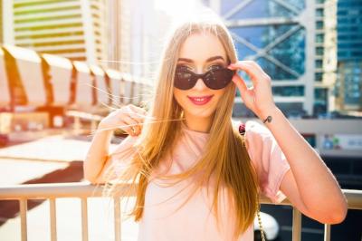 Candid Capture of a Cheerful Young Woman Posing with Sunglasses – Free Download