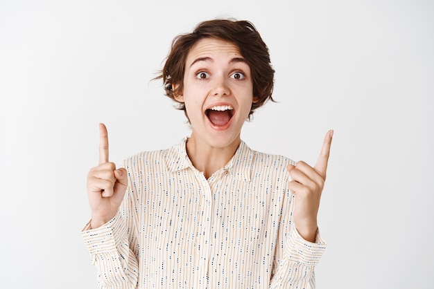 Excited Woman Pointing Up in Joy â Free Stock Photo Download