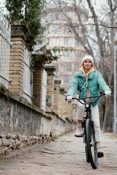 Woman Riding a Bicycle on the Sidewalk – Free Stock Photo for Download