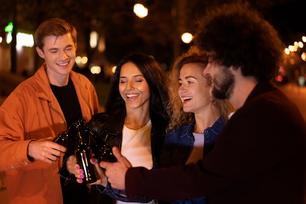 Friends Enjoying Beer on a Night Out – Download Free Stock Photo