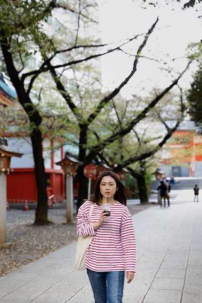 Young Woman Walking Through the Neighborhood – Download Free Stock Photo