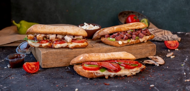 Three Varieties of Baguette Sandwiches with Mixed Foods on a Stone Table – Download Free Stock Photo