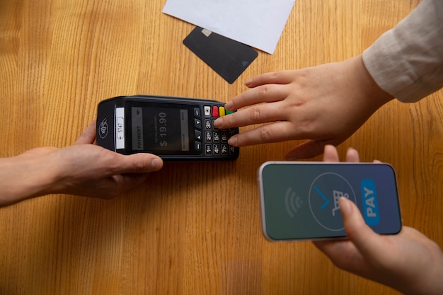 High Angle Customer Using NFC Device for Payment – Free Download