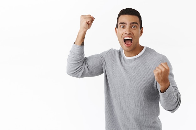 Excited Athletic Man Celebrating with Hands Raised – Free Download