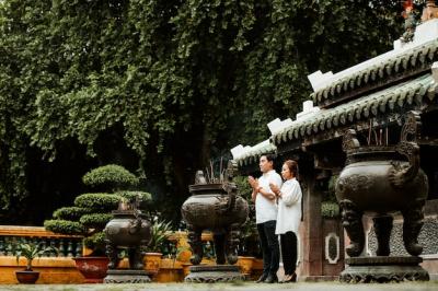 Couple Praying at Temple Surrounded by Burning Incense – Free Download