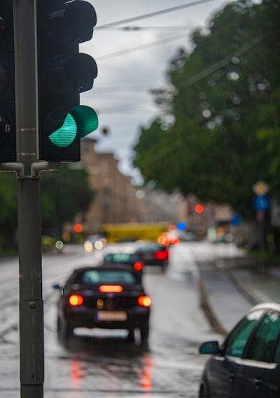 Green Traffic Light in the Rain: Cars Driving By – Free Download