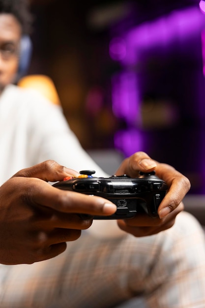 Close-Up Shot of Gamepad Controller in BIPOC Man’s Hands Playing Video Game – Free Download