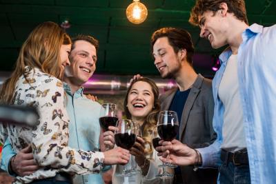 Happy Friends Enjoying Evening Drinks in Bar – Free Download