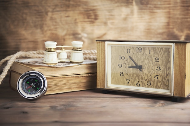 Alarm Clock, Compass, and Book on Wooden Table – Free Stock Photo for Your Projects