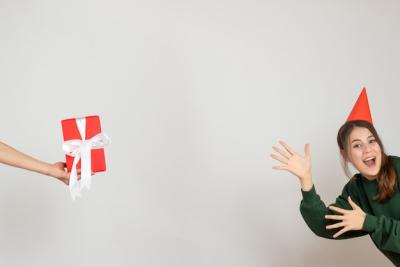 Happy Girl in Party Cap with Gift – Free Stock Photo for Download