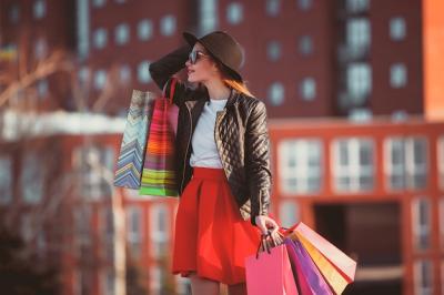 Girl Walking with Shopping Bags in the City on a Sunny Day – Free Download