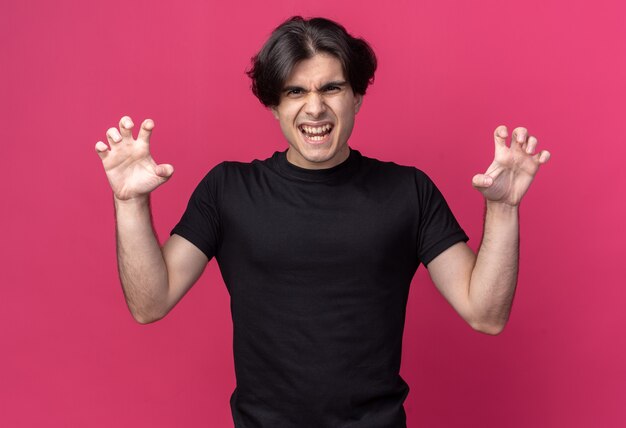 Handsome Young Guy in Black T-Shirt Doing Tiger Style Gesture on Pink Wall – Free Download